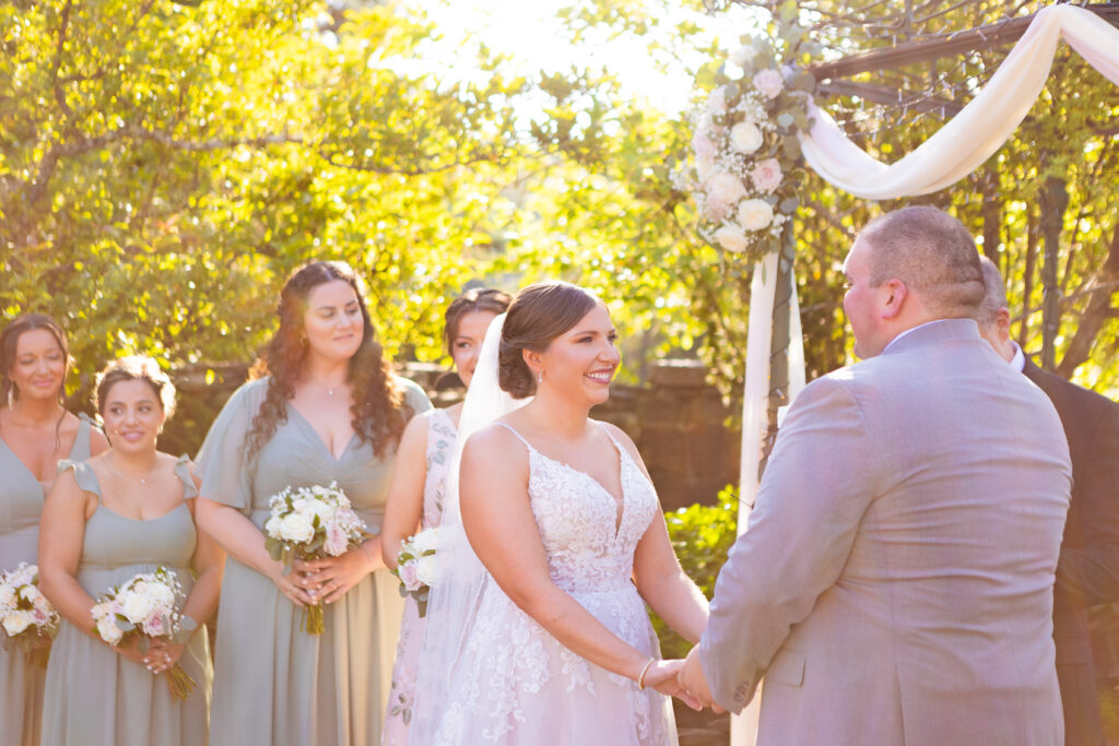 Bride laughing during her wedding ceremony.