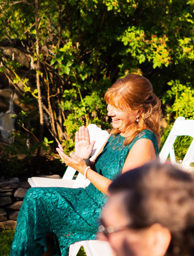 Mother of the bride laughing during the wedding ceremony.