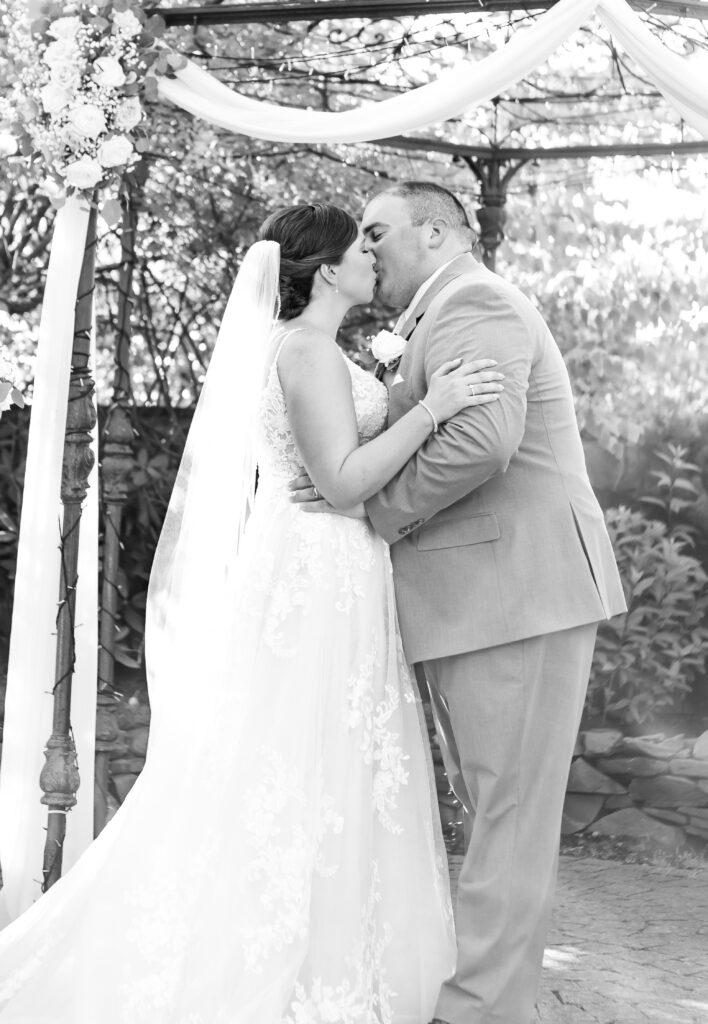 Bride and groom share their first kiss.