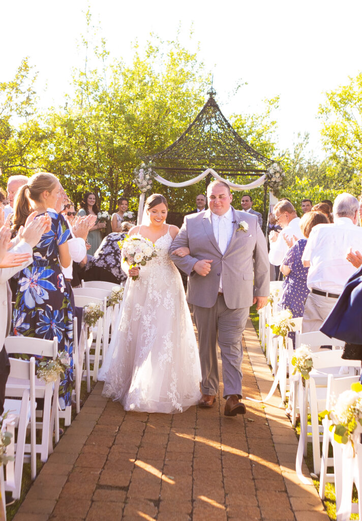 Bride and groom walk down the aisle together as a married couple.