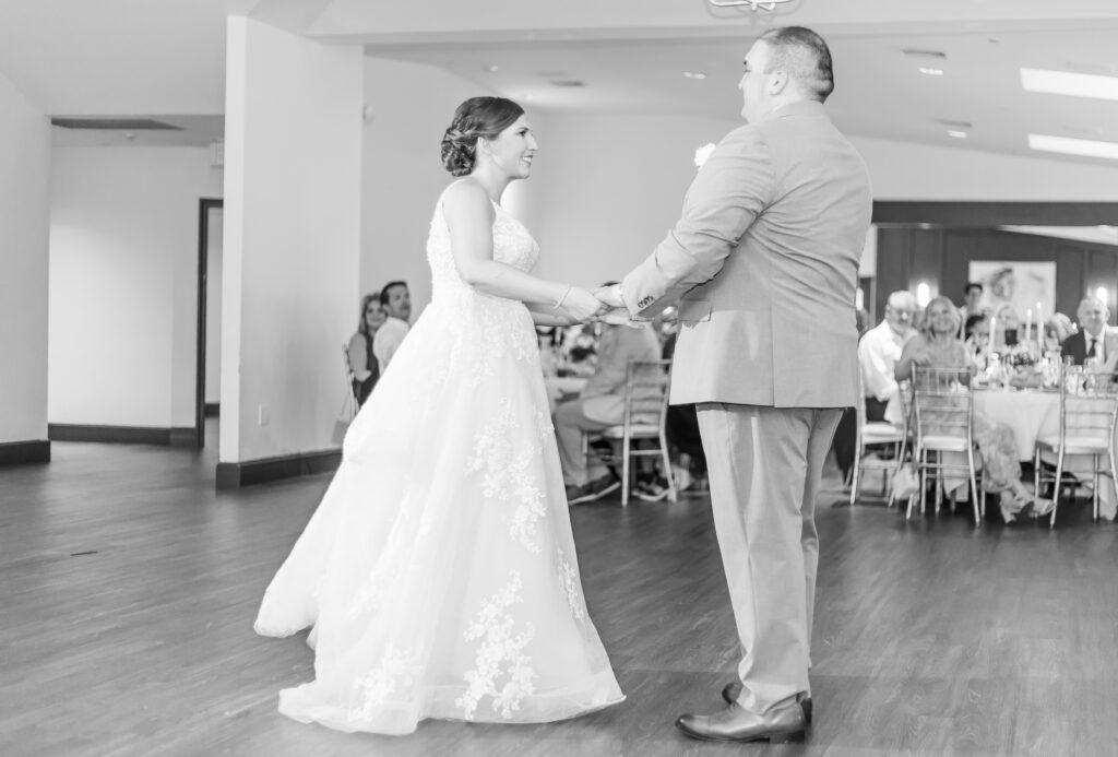 Groom twirls the bride during the first dance.