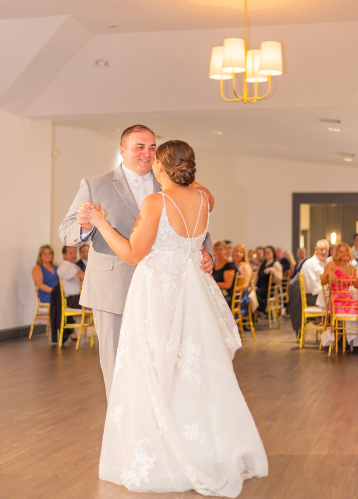 Groom looks into the bride's eyes during their first dance as a married couple at the Granite Rose.