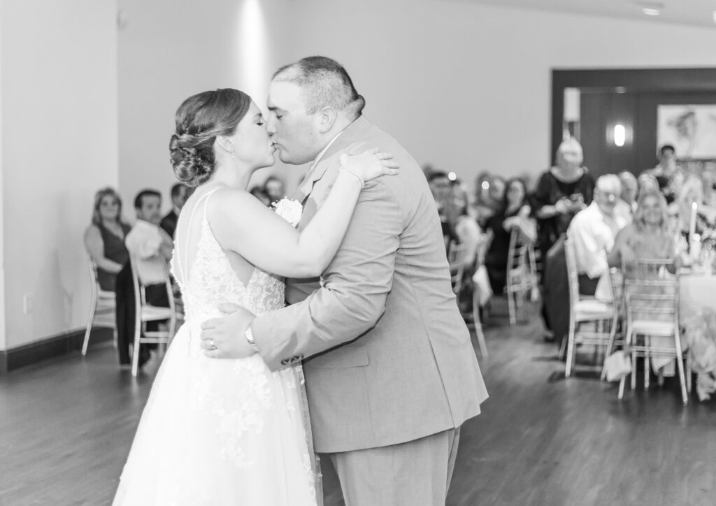 Bride and groom share a kiss after their first dance.