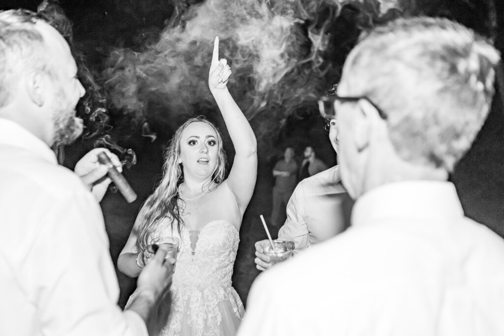 Bride enjoying a cigar at her wedding.