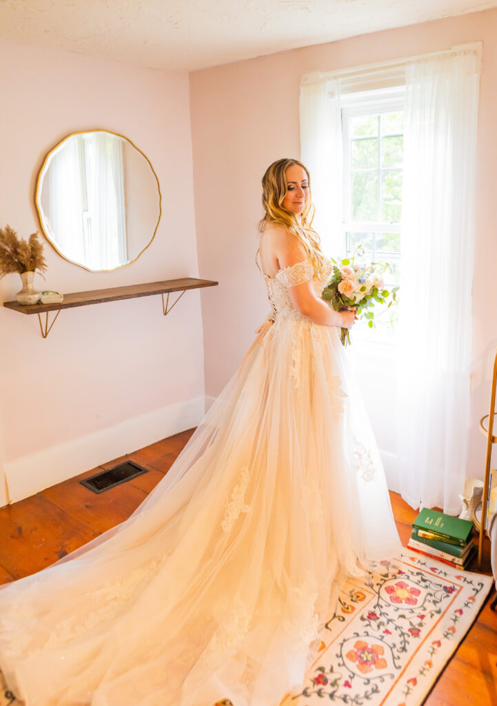 The bride is looking over her shoulder and is ready to walk down the aisle.