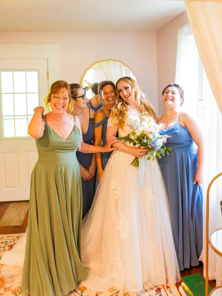 The bride is surrounded by her wedding party as she finishes getting ready for her big day at Stone Garden.