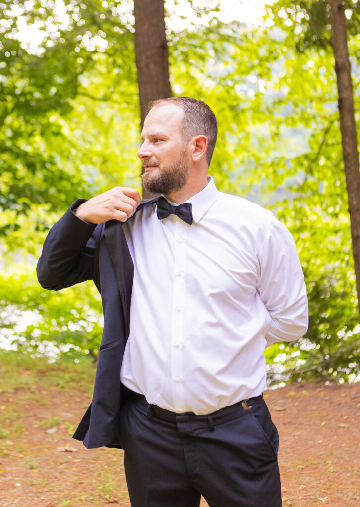 Groom putting his jacket halfway on.