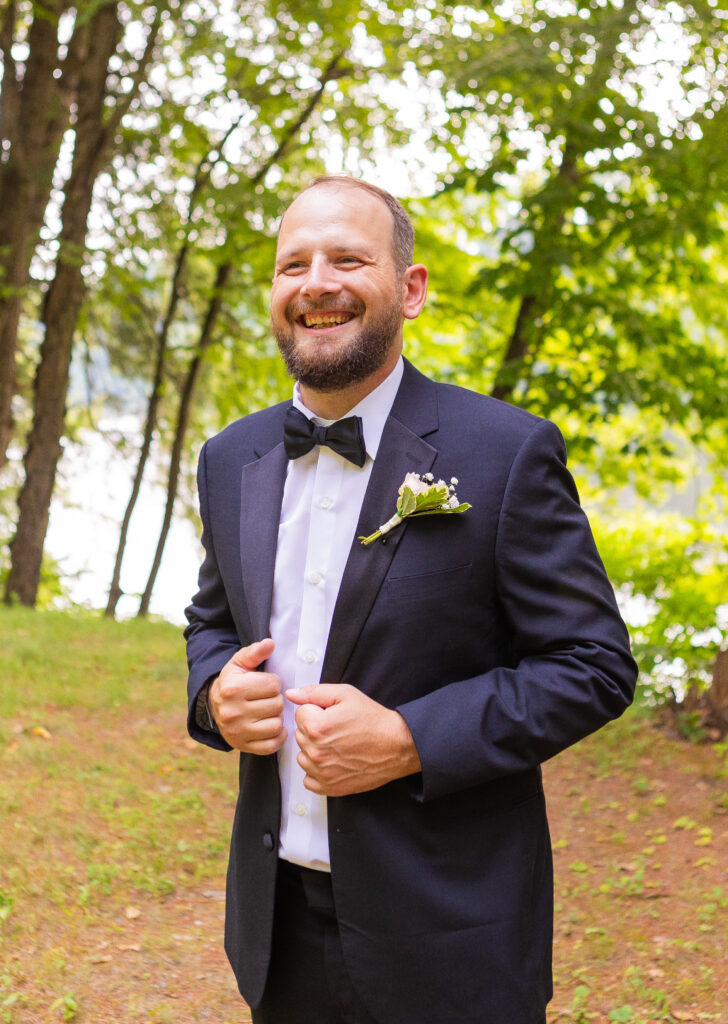 Groom laughing at his groomsmen.