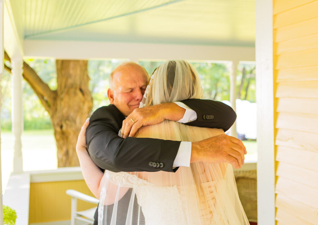 Father hugging his daughter on her wedding day in New Hampshire.