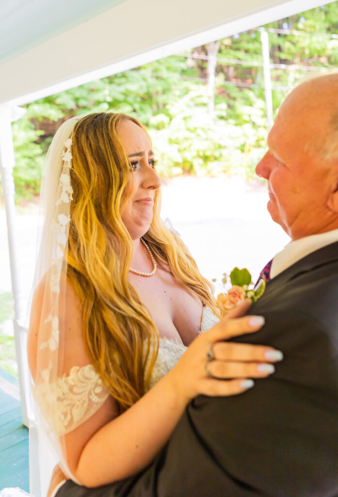 Bride tearing up with her Dad during their first look.