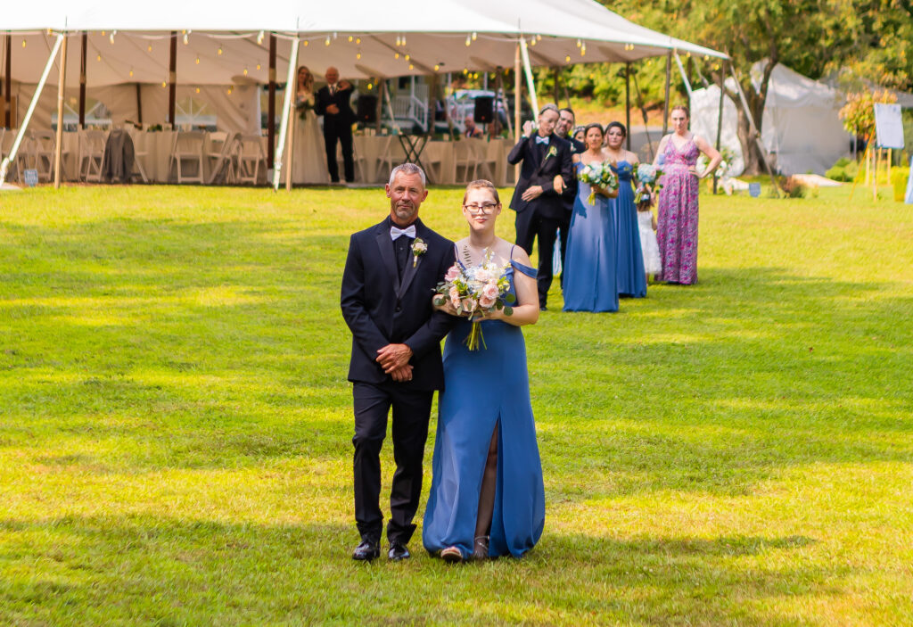 Goromsmen walking with briesmaid down the aisle.