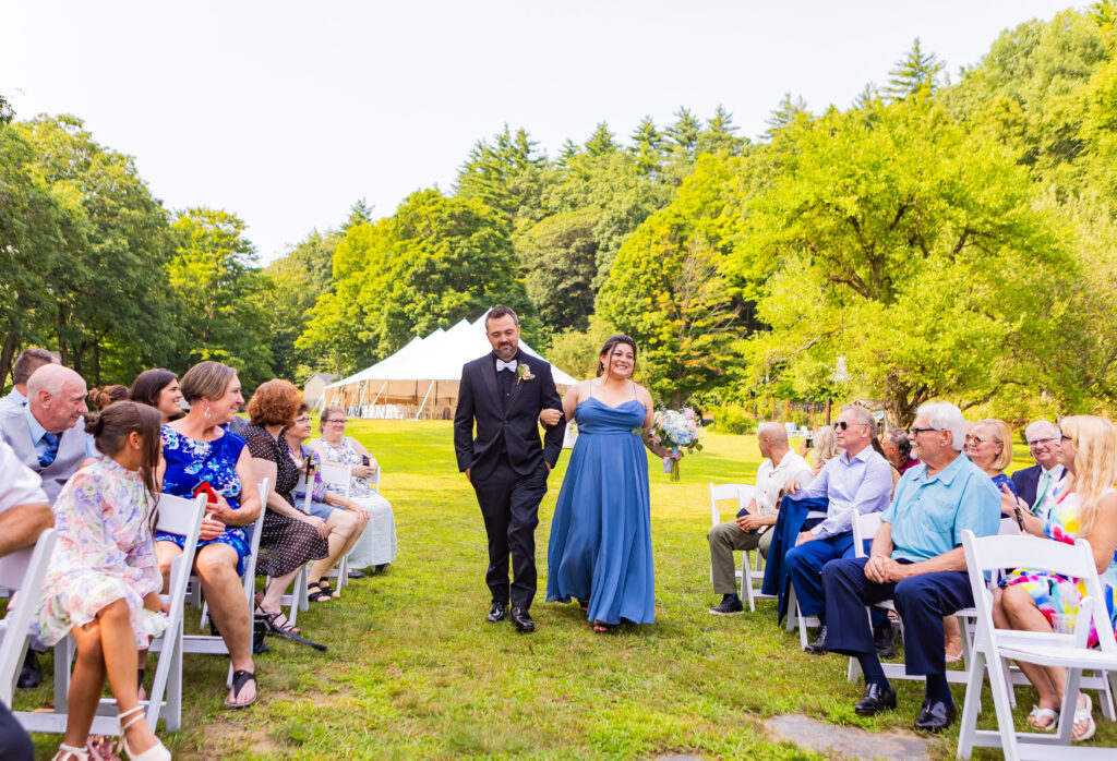 Maid of honor and best man walking together down the aisle at a wedding at Stone Garden.