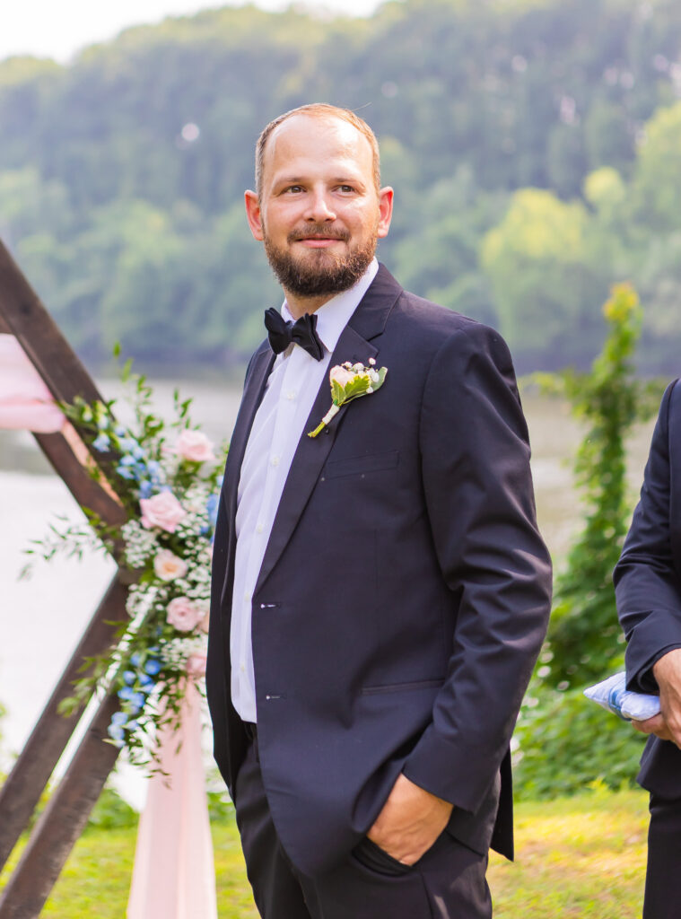 Groom watches his bride coming down the aisle to forever. 