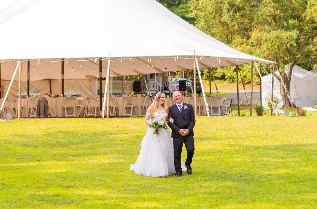 Bride and father walk together down the aisle at their wedding near Concord, NH.