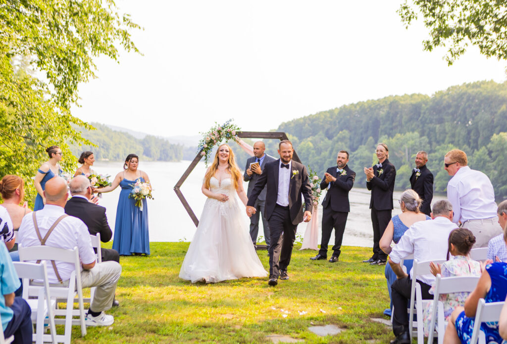 Bride and groom walk back down the aisle as husband and wife for the first time. 