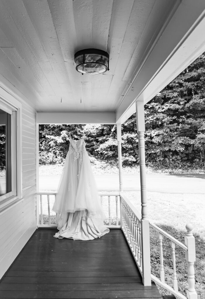 NH wedding dress hanging on the porch at Stone Garden in Westmoreland, NH.