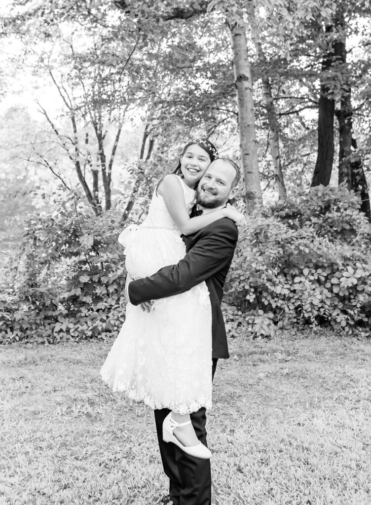 Groom picks up his daughter on his wedding day in New Hampshire.