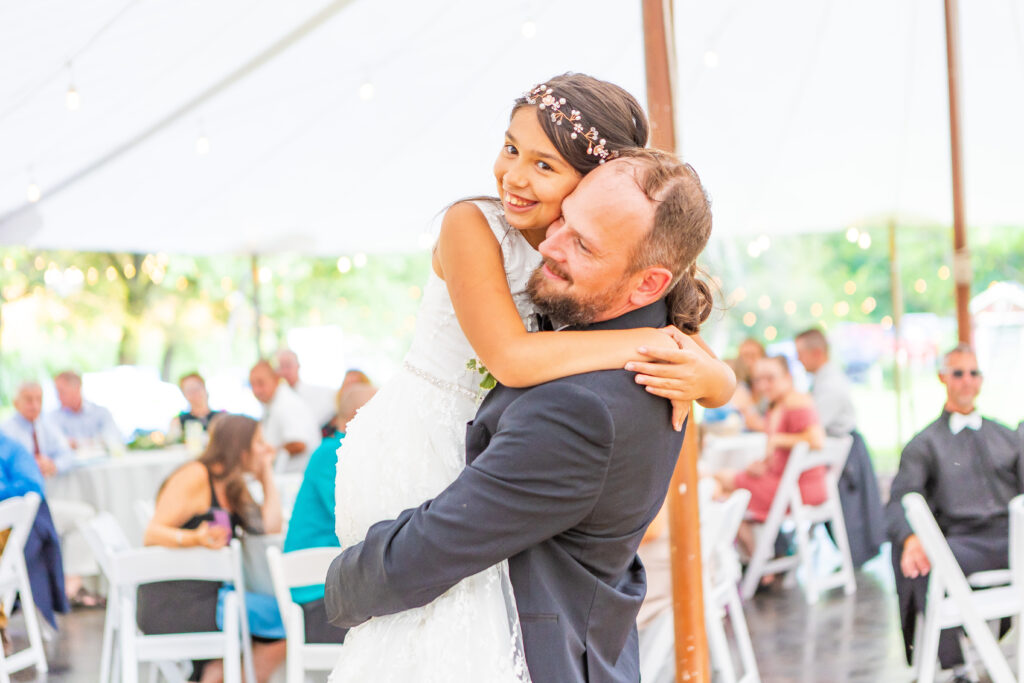 Groom and his daughter share a dance. 