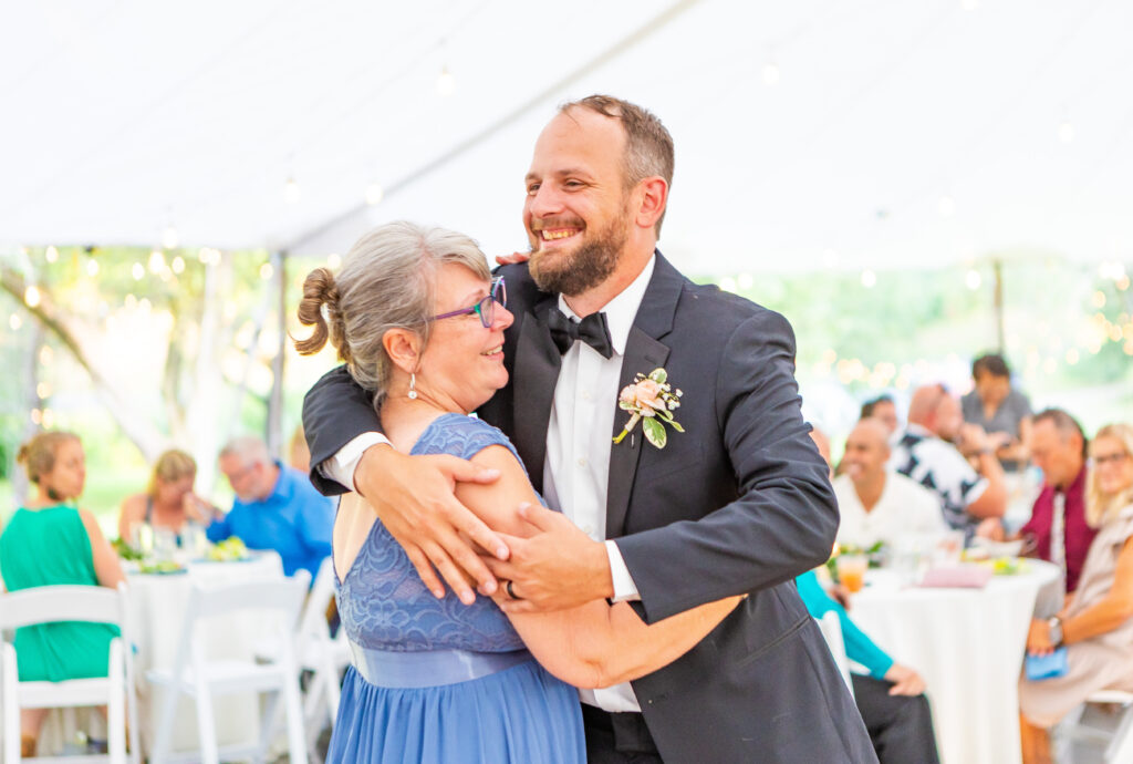 Groom and his mom share a mother son dance.