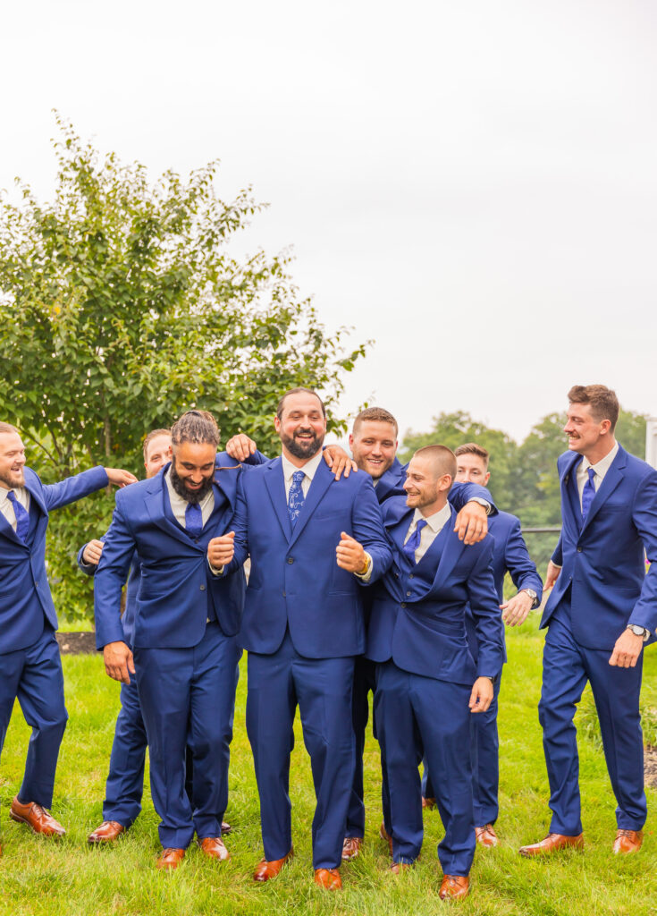 Groomsmen going in for a hug