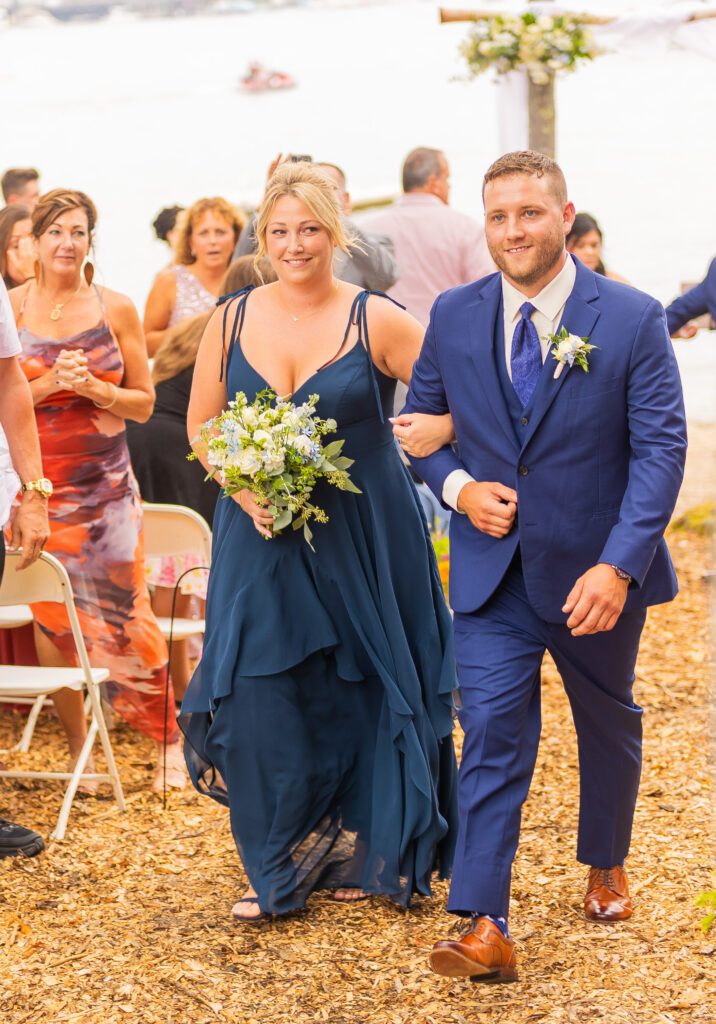 groomsmen walk with the bridesmaid.