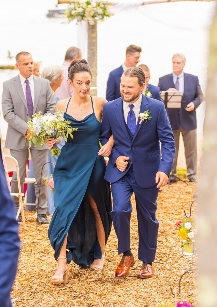 wedding party walking together back up the aisle.