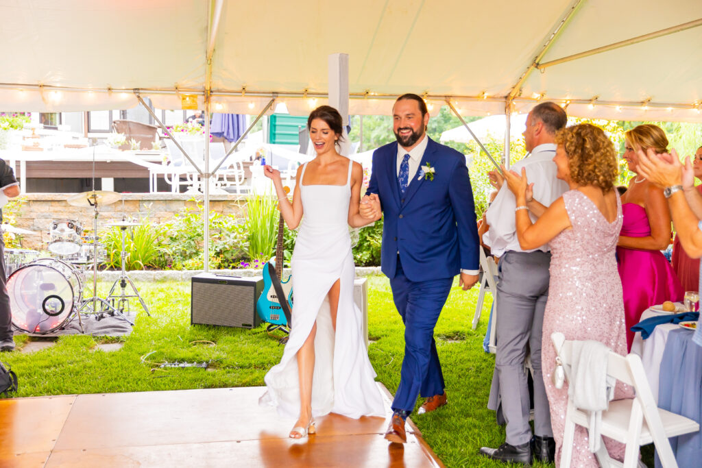 Bride and groom entering their reception.