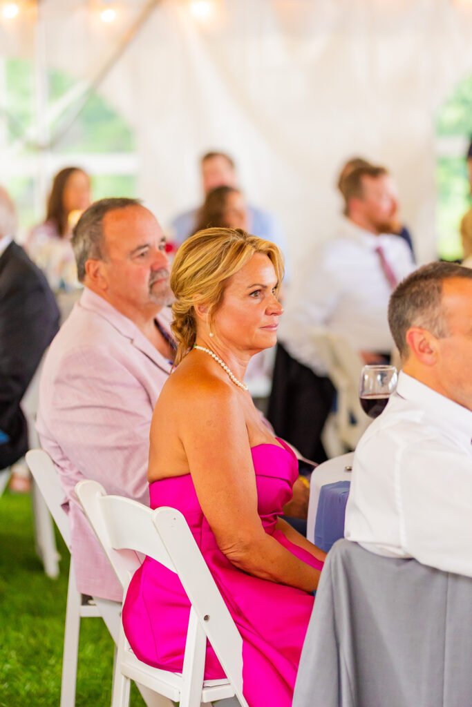 Mother of the groom stares proudly at her son.