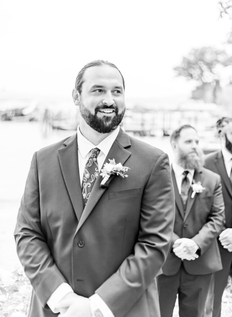 Groom seeing his bride for the first time as she walks down the aisle.