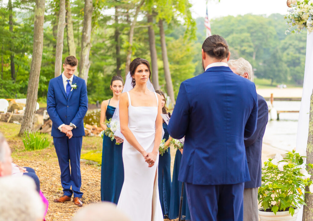 The bride is listening to the groom's vows.