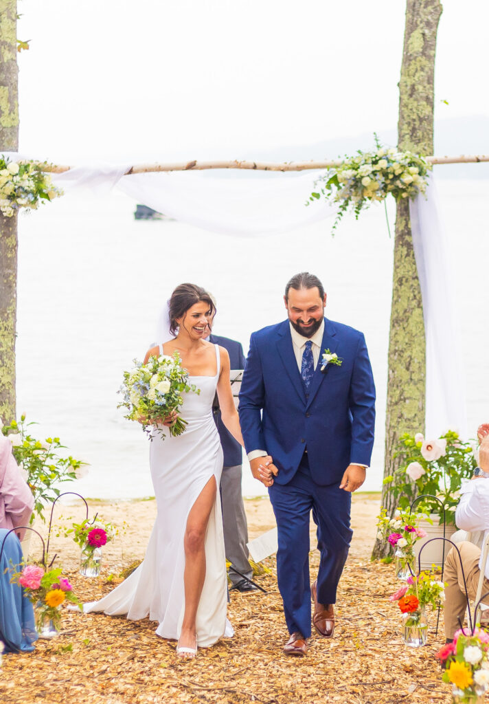 Bride and groom walk up the aisle after their ceremony.