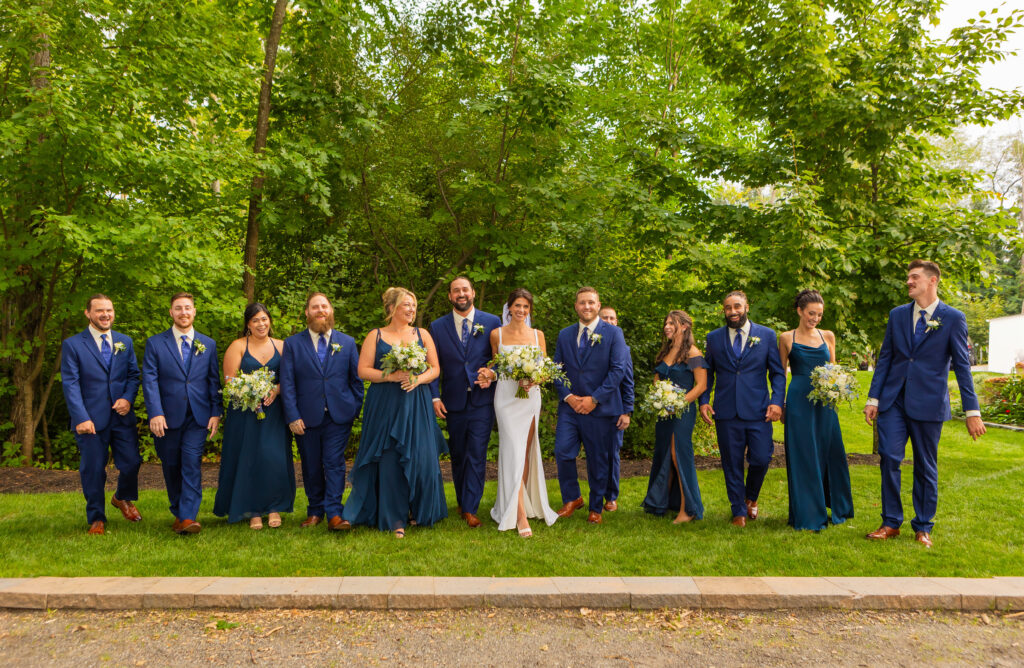 Bride and groom walking with their wedding at a NH backyard wedding.