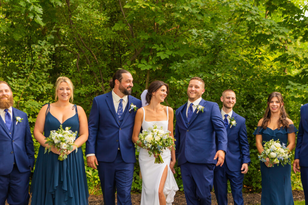 Bride and groom laughing with the best man.