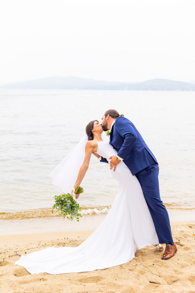 Bride and groom share a dip on from of the White Mountains.