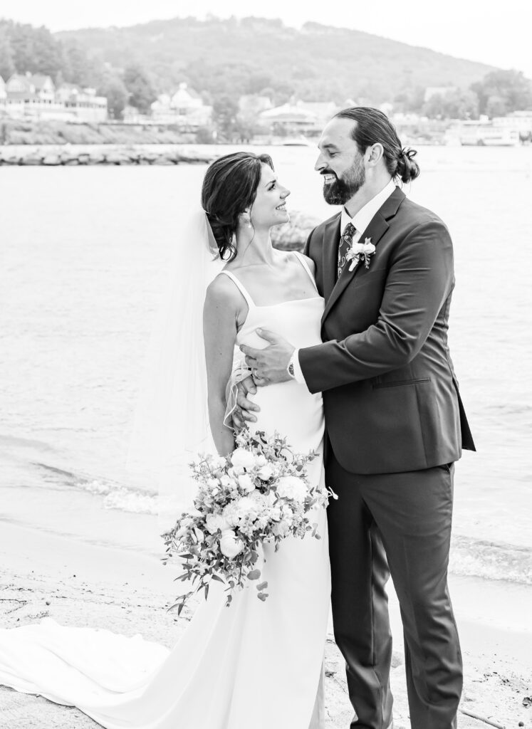 Bride and groom hold each other moments after their NH beach wedding.