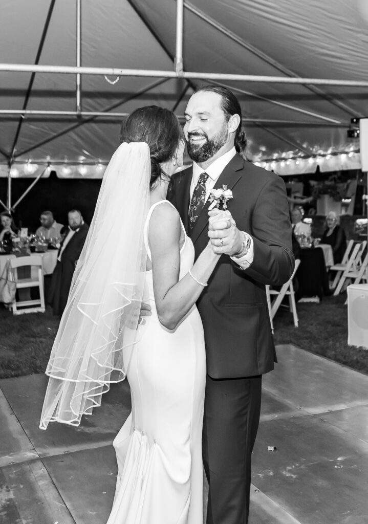 Groom laughs with bride during their first dance.