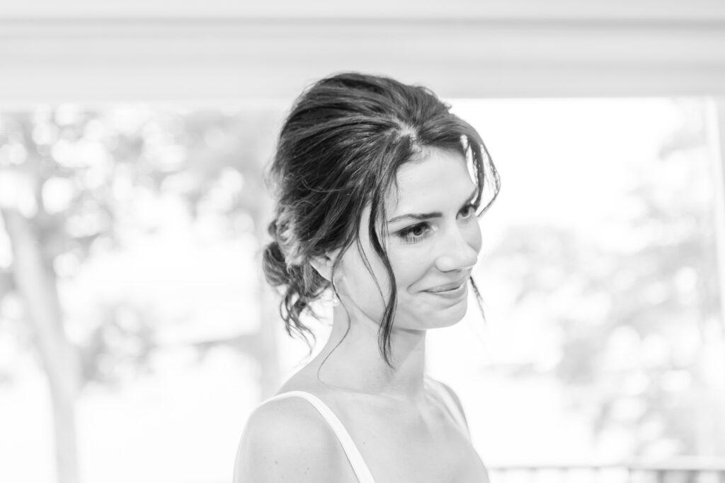 Bride looks at herself in the mirror.