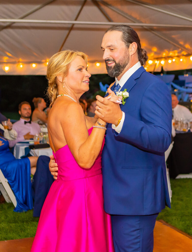 Groom and mother dancing together.