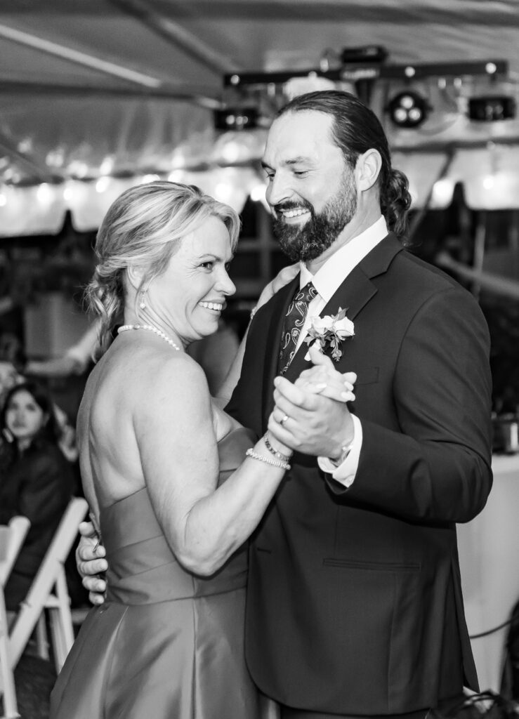 Groom and mother laugh together.