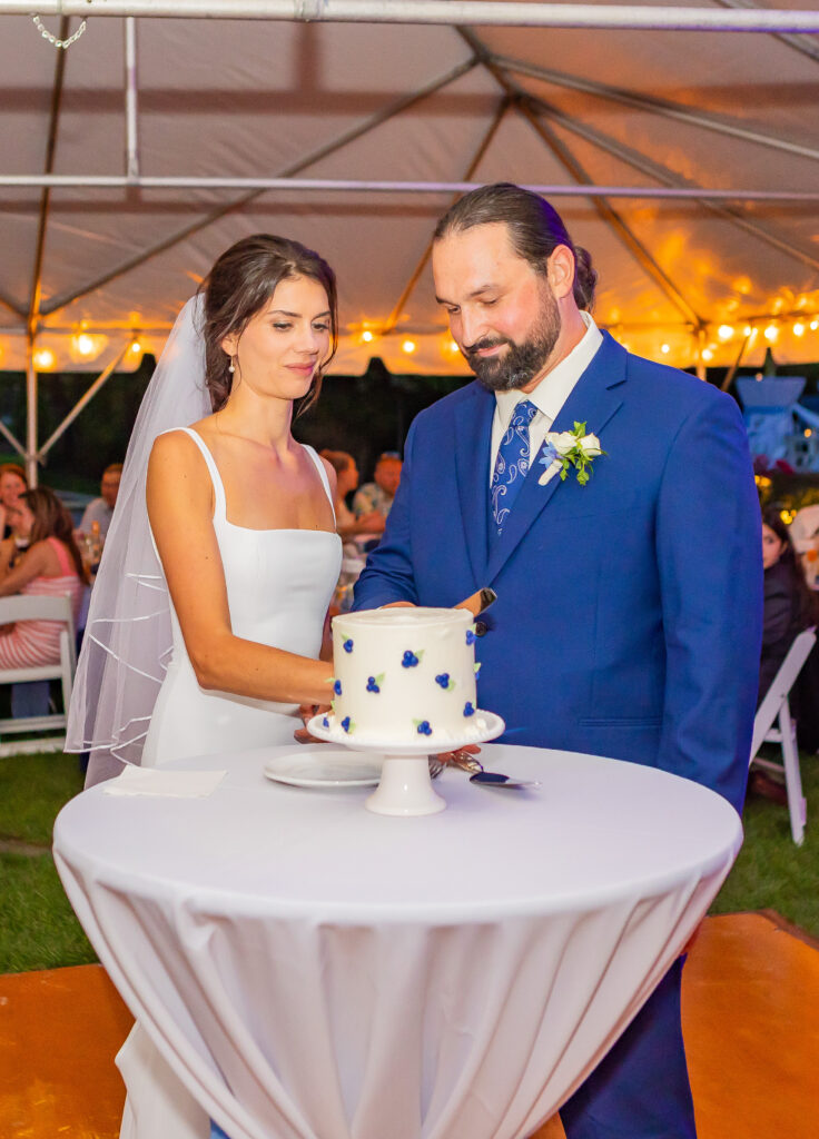 Bride and groom cutting their NH wedding cake.