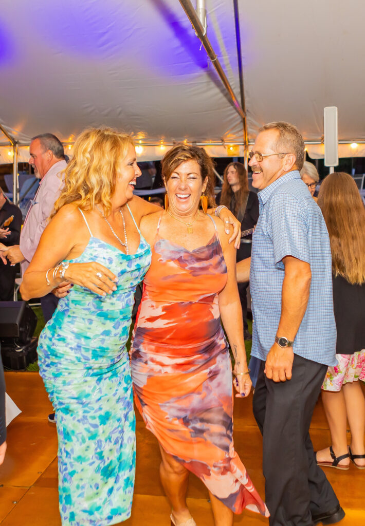 Guests dance and laugh together.