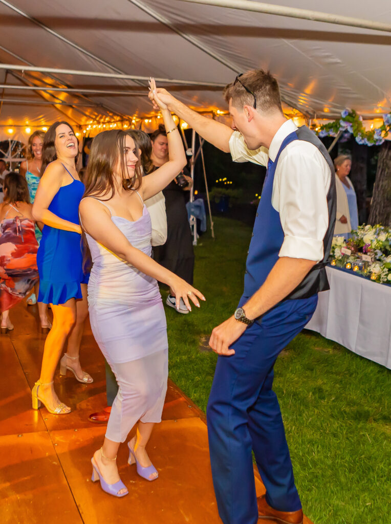 Wedding guests dancing together.