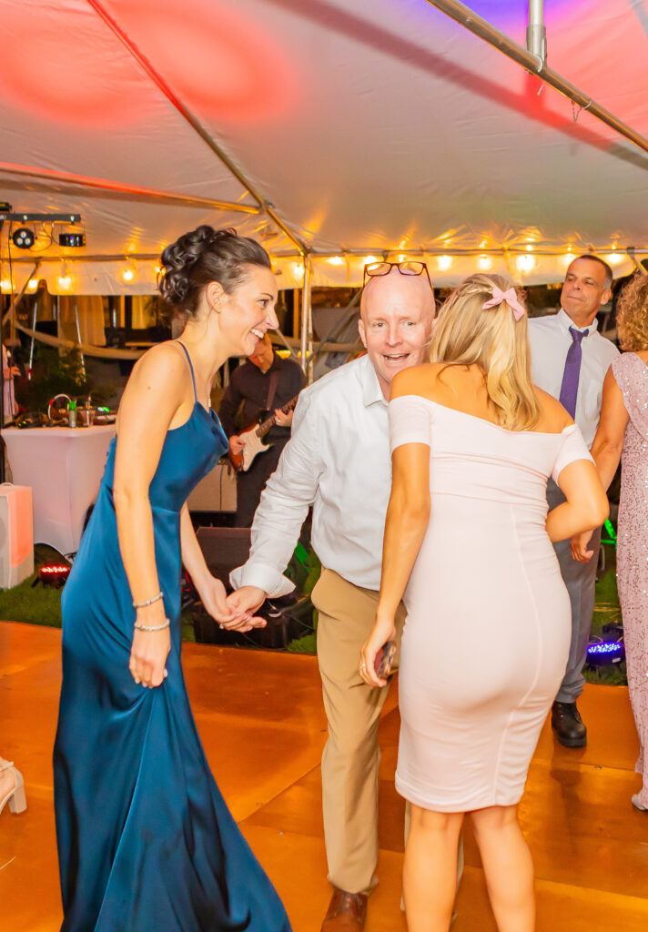 Bridesmaids dancing with wedding guests.