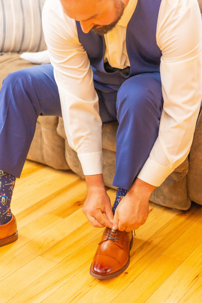 groom ties his shoes.