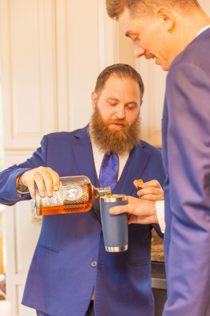 The groomsmen pour shots to share