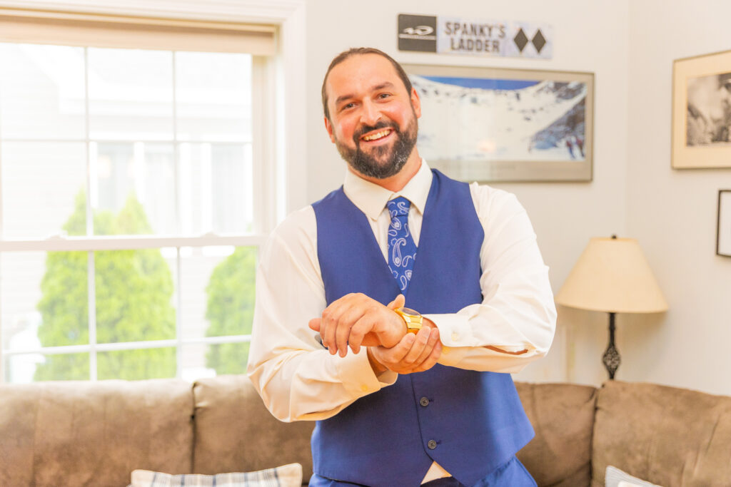 Groom puts on his wedding watch.