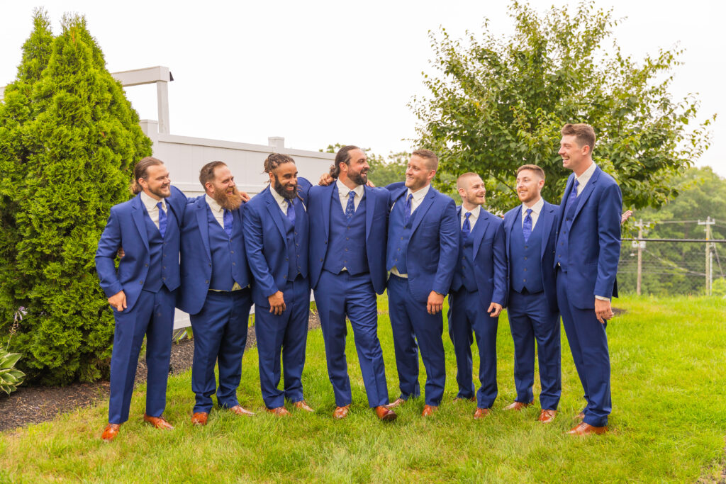 Groomsmen laugh at eachother.