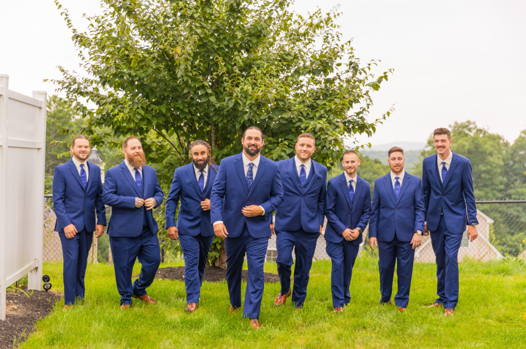 Groomsmen walk together all ready for the wedding.