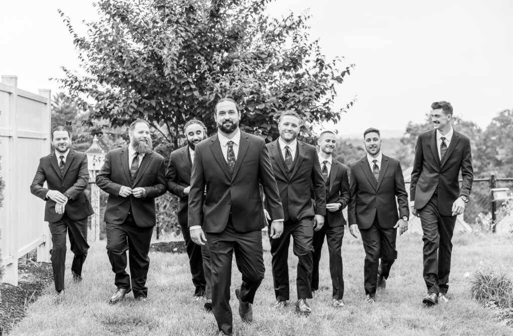 Groomsmen walk and laugh together