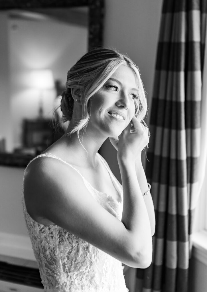 bride putting her earrings on